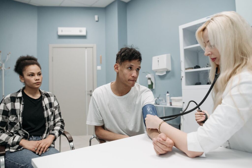 A doctor checking a patient’s blood pressure